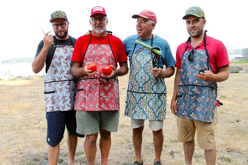 4 men wearing Splash Fabric aprons and starting to cook