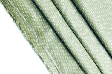 Folded fabric with a light green fabric. Grass green fabric. 100% cotton.
