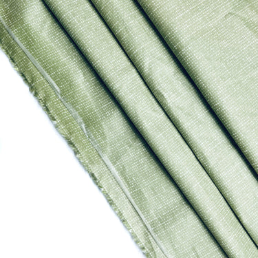 Folded fabric with a light green fabric. Grass green fabric. 100% cotton.
